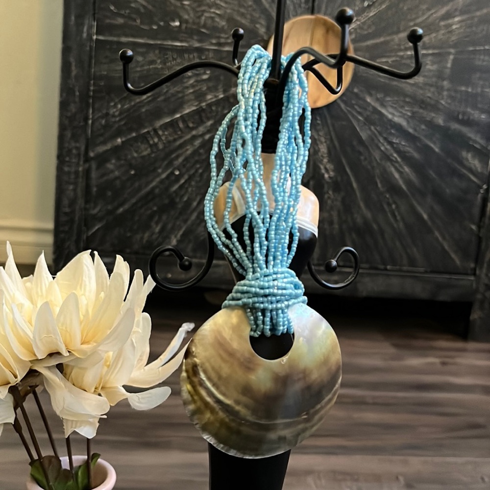 Handmade Artisan necklace made out of beads and seashell.